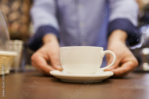 Image of barist man with cup of coffee