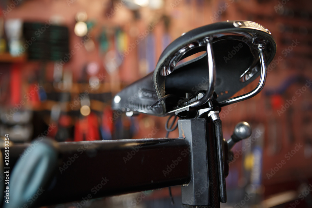 Photo of close-up of bicycle seat in workshop. Photo of close-up of bicycle seat in workshop.