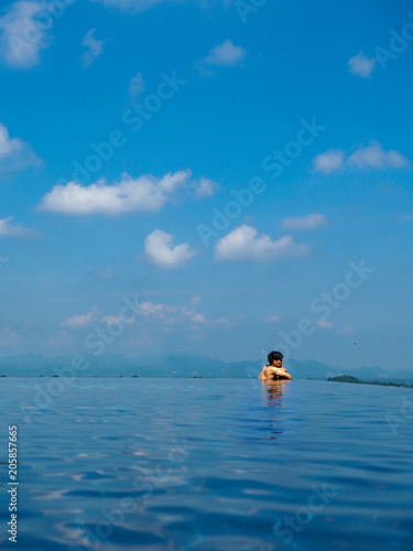 Infinity pool view with a man at the edge