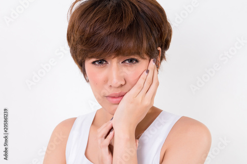 Teeth Problem. Woman feeling tooth pain. Isolated on white background. Studio lighting. Concept for healthy and medical