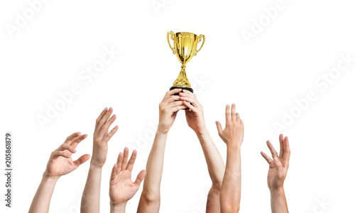 Many hands raised up. Winner is holding trophy in hands. Isolated on white background.