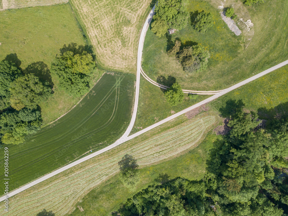 Aerial view of road through rural landscape in Switzerland on a warm summer day