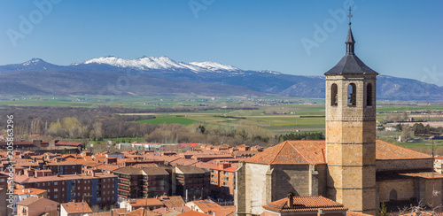 Panorama of church tower and snowcapped mountains near Avila, Spain