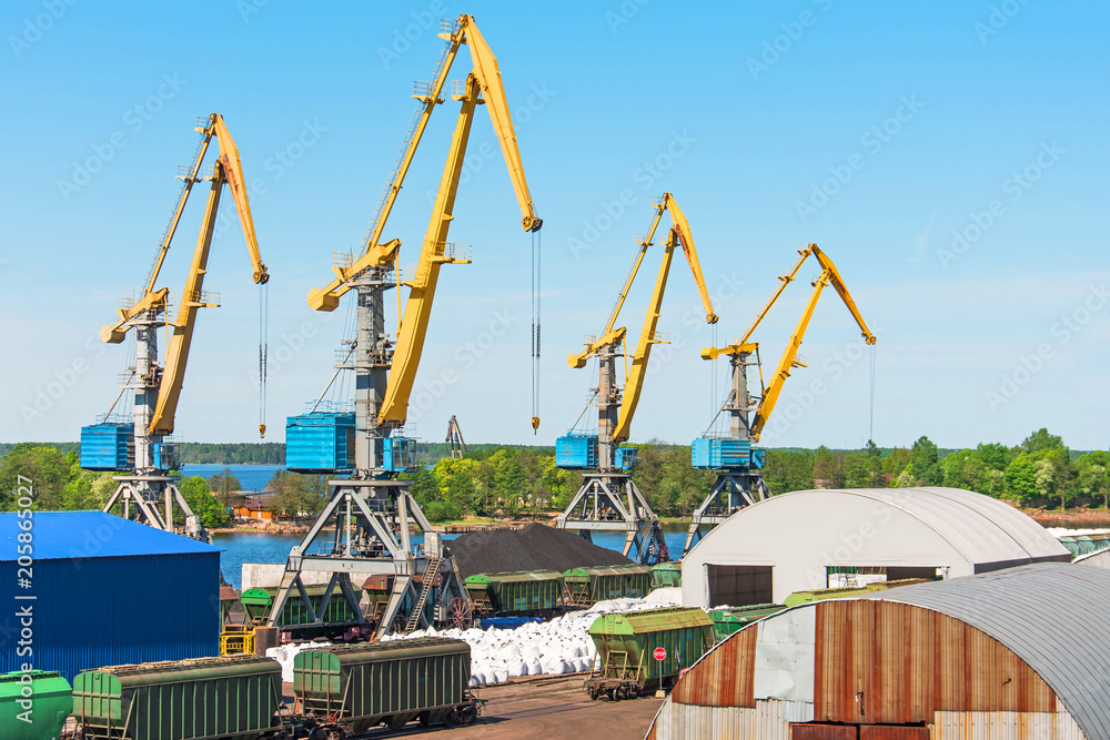 View of the cargo port, with high sea cranes for loading goods and cargo to ships from the pier of the railway station.
