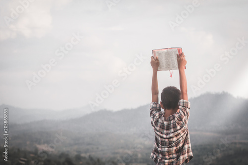 Boy raised the Bible. photo