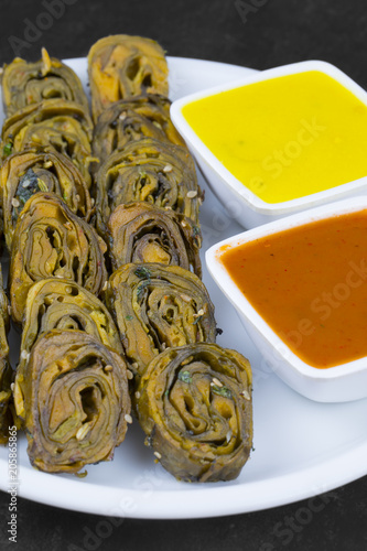 Indian Spicy Food Patra Also Called Paatra, Alu Vadi or Patrode is a Veg Dish in Maharashtra or Gujarati Cuisine. It is Made from Colocasia Leaves Stuffed with Rice Flour And Spices, Tamarind, Jaggery photo