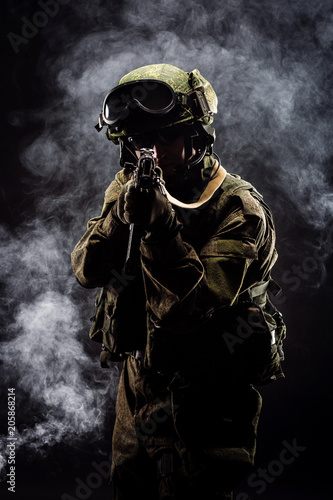 russian special forces soldier with rifle on dark background. army  military and people concept