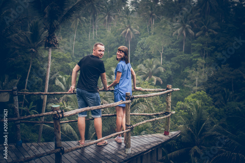 Traveler honeymoon couple in the jungle of Bali island, Indonesia. Couple in the rainforest.