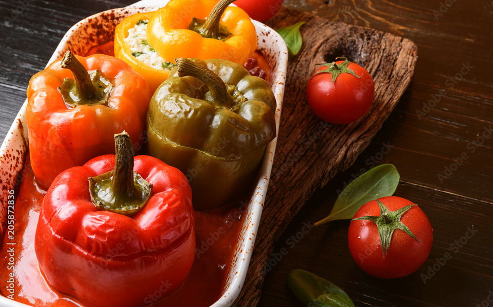 homemade, stuffed peppers. with a filling of basil, spinach, cheese and spices. with gravy from fresh home-made tomatoes. made in a rustic style. homemade, stuffed peppers. with a filling of basil, spinach, cheese and spices. with gravy from fresh home-made tomatoes. made in a rustic style.