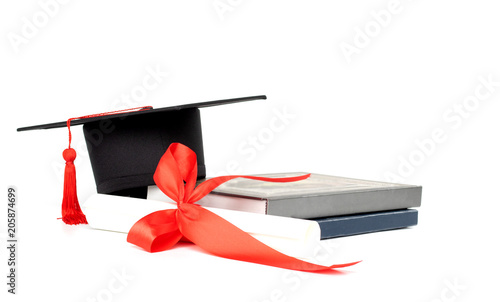 Graduation hat, book and diploma isolated on white background