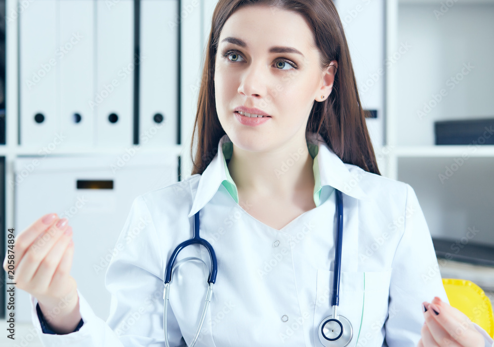 Young female doctor giving a consultation to a patient and explaining medical informations and diagnosis Young female doctor giving a consultation to a patient and explaining medical informations and diagnosis