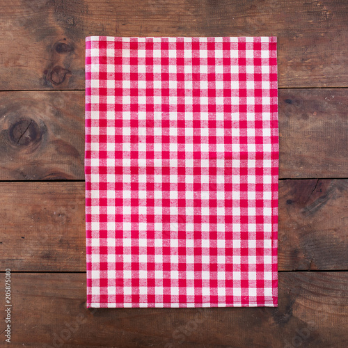 Red classic  Checkered table cloth on wooden table, background with copy space, close up