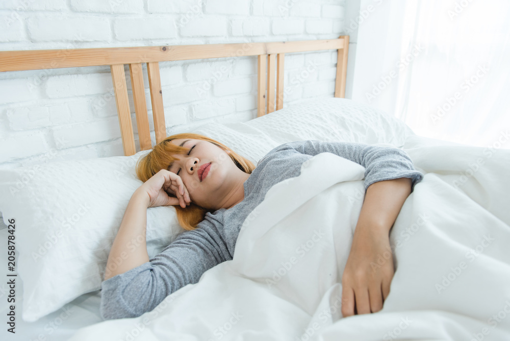 Beautiful young Asian woman sleeping in bed in the morning. Attractive asian girl use bedtime in her comfortable bedroom. Relaxation bedroom. Iifestyle asia woman at home concept. Beautiful young Asian woman sleeping in bed in the morning. Attractive asian girl use bedtime in her comfortable bedroom. Relaxation bedroom. Iifestyle asia woman at home concept.