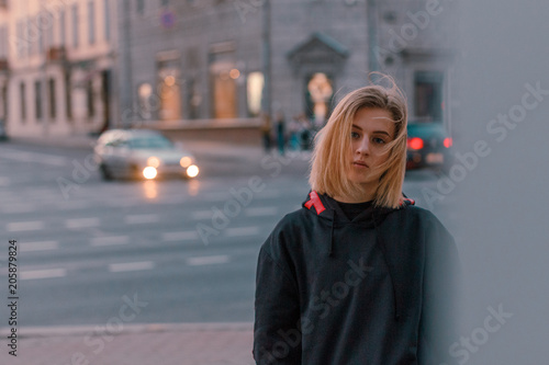 portrait of a beautiful young blonde girl in a night city
