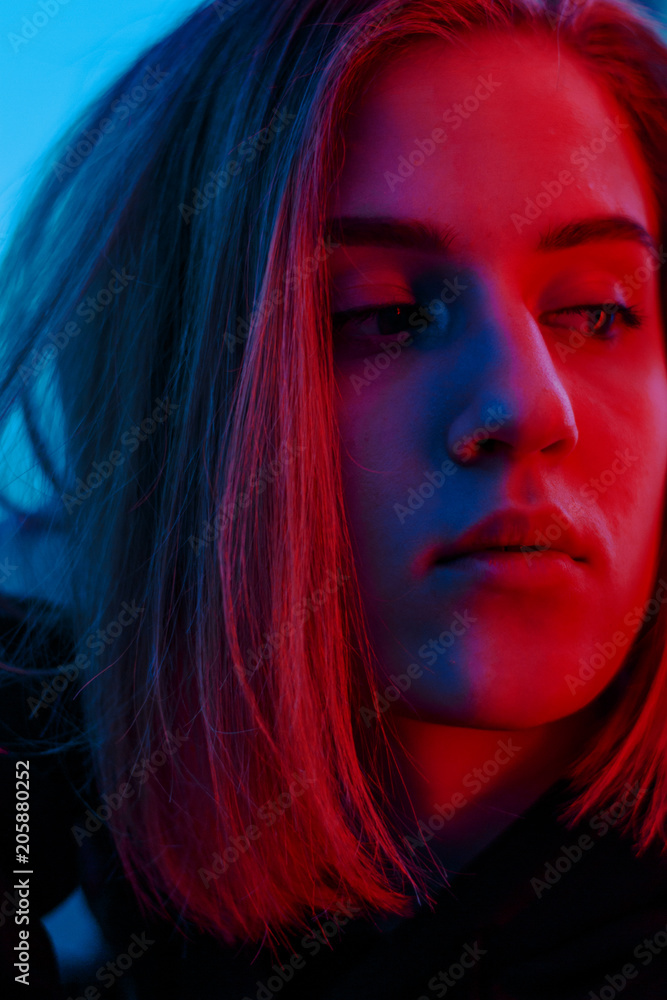 portrait of a girl in red blue in the street