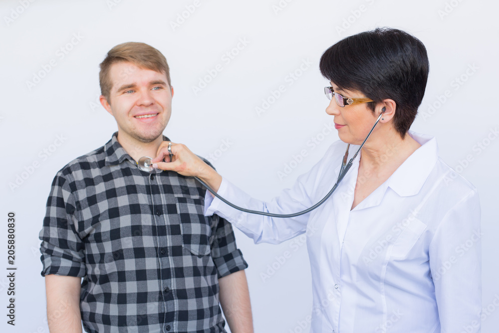 Portrait of confident doctor checking heartbeat of patient Portrait of confident doctor checking heartbeat of patient