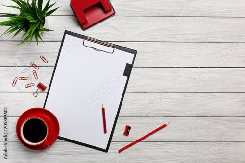 white table boards folders red notebook cup morning coffee clock paper clips keyboard mouse office worker office