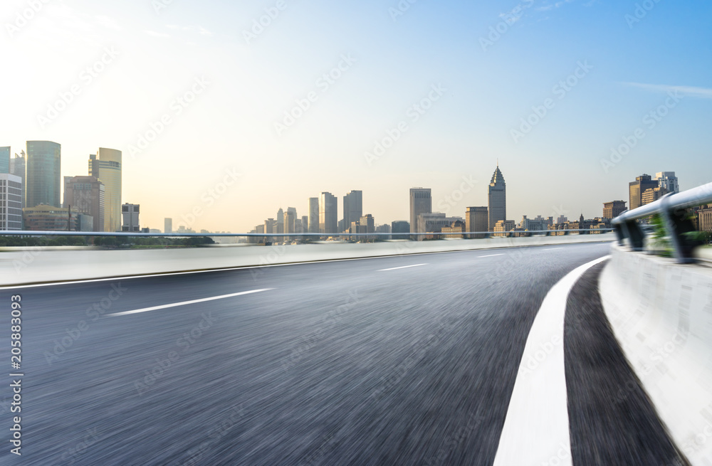 Fototapeta premium empty road with panoramic city skyline