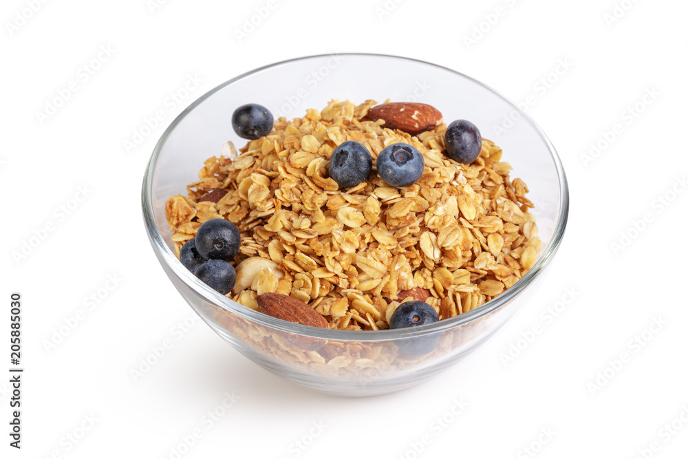 Bowl of homemade granola with fruit pieces isolated on white Bowl of homemade granola with fruit pieces isolated on white