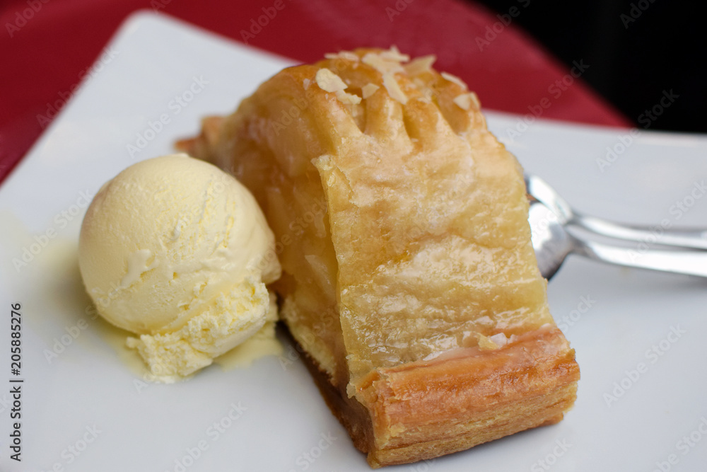 Apple pie and ice cream on a plate. 