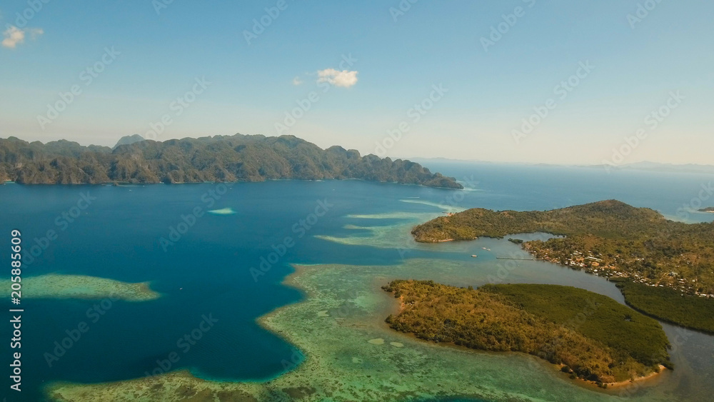 Aerial view: beach, tropical island, sea bay and lagoon, mountains with rainforest, Busuanga, Palawan. Seascape, tropical landscape Azure water of lagoon Philippines