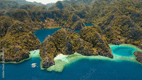 Aerial view: Mountain Barracuda lake, on tropical island, Lagoon with blue, azure water. Lake in the mountains covered with tropical forest on the island Coron, Palawan, Philippines. 4K video, Travel