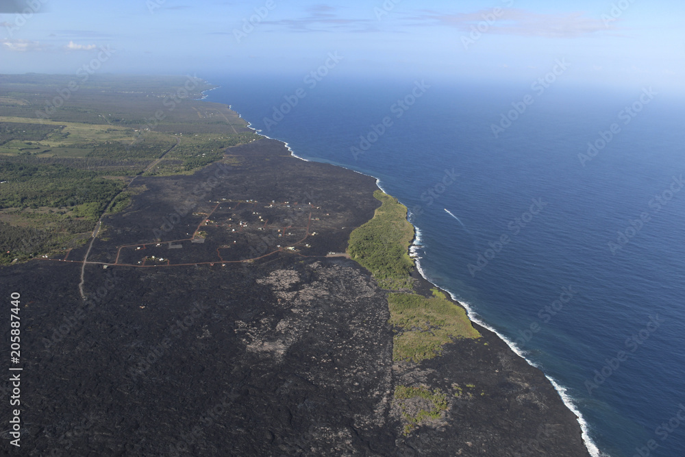 Helicopter aerial view of lava field by the ocean, Big Island, Hawaii