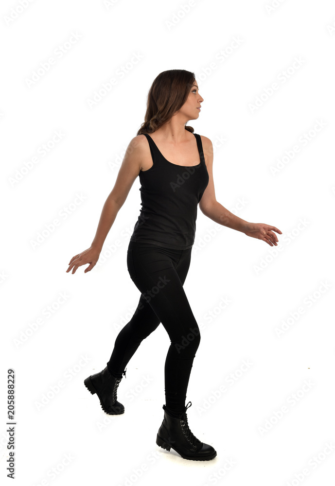 full length portrait of brunette girl wearing black singlet, jeans jeans and boots. standing pose, isolated on white studio background. full length portrait of brunette girl wearing black singlet, jeans jeans and boots. standing pose, isolated on white studio background.