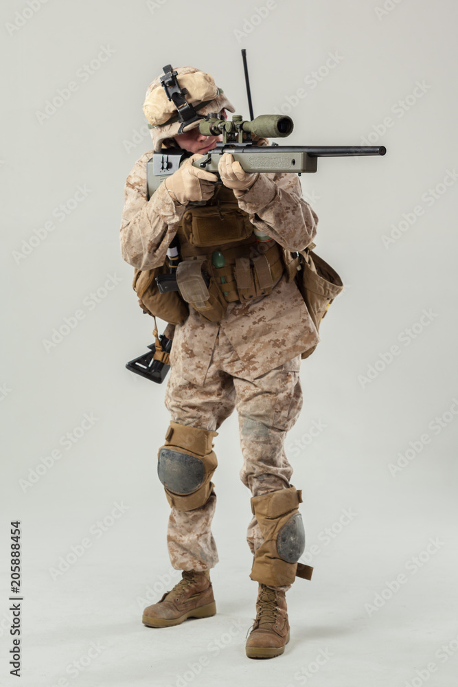 Soldier in camouflage holding rifle Soldier in camouflage holding rifle