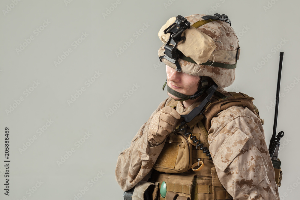 Soldier in camouflage holding rifle Soldier in camouflage holding rifle