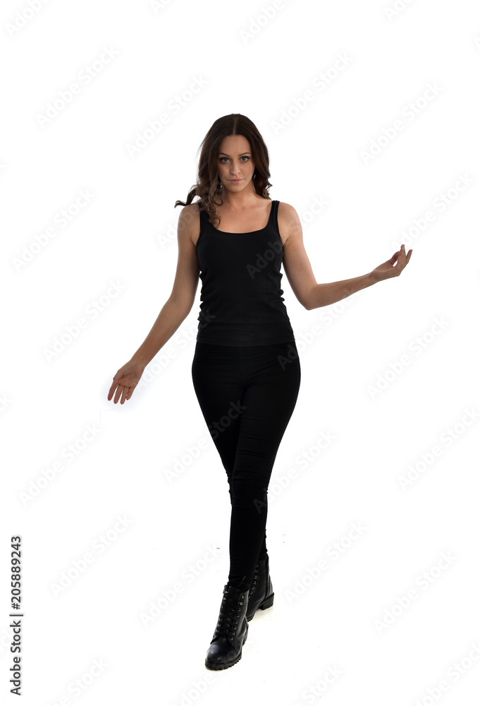 full length portrait of brunette girl wearing black singlet, jeans jeans and boots. standing pose, isolated on white studio background. full length portrait of brunette girl wearing black singlet, jeans jeans and boots. standing pose, isolated on white studio background.