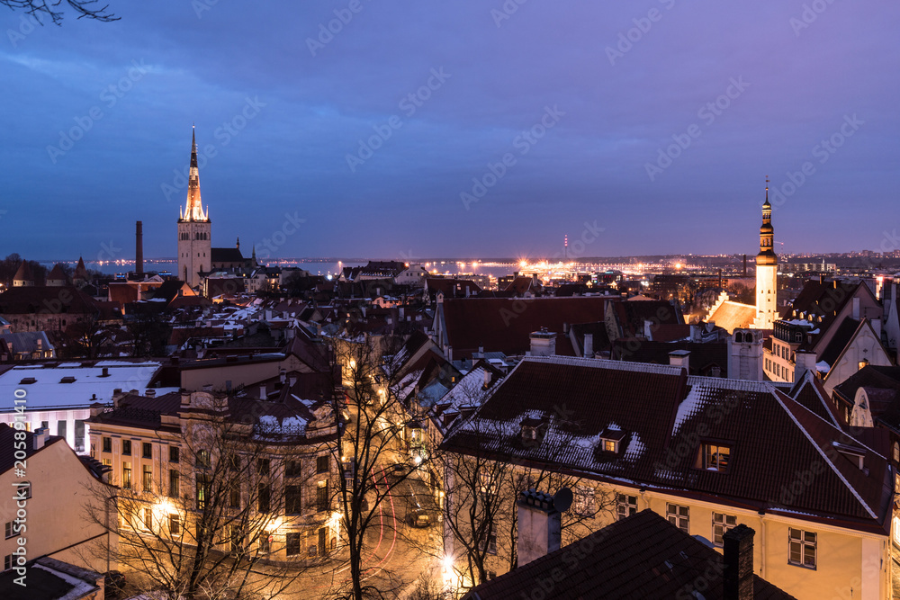Twilight over the Tallinn old town cityscape with the Saint Olaf church in Estonia capital city.