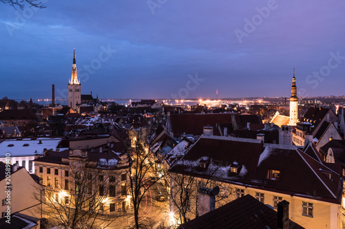 Twilight over the Tallinn old town cityscape with the Saint Olaf church in Estonia capital city.