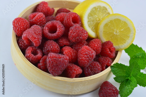 Raspberry in the bowl and lemon