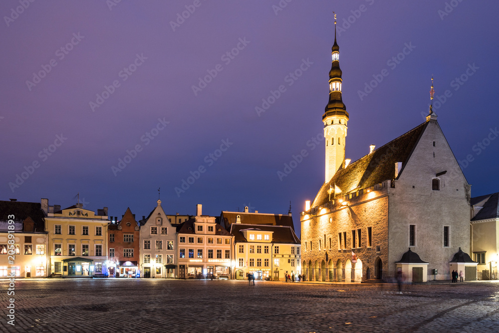 The Tallin gothic Town Hall building on the main old town square at night in Estonia capital city in winter. Tallinn is a popular travel destination in North Europe.