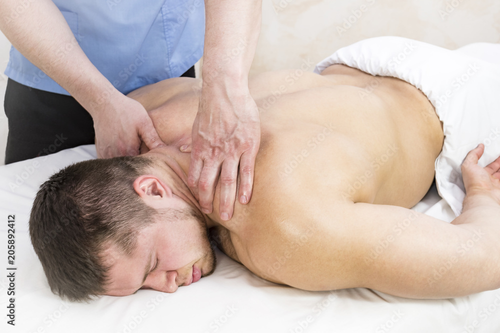 Young man on wellness treatments sports massage Young man on wellness treatments sports massage