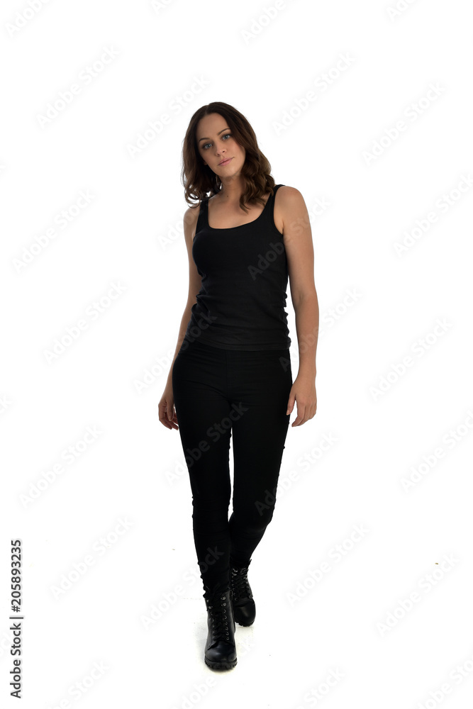 full length portrait of brunette girl wearing black singlet, jeans jeans and boots. standing pose, isolated on white studio background. full length portrait of brunette girl wearing black singlet, jeans jeans and boots. standing pose, isolated on white studio background.