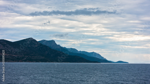 Dramatic clouds over Aegean sea with Pelion mountain in background, Greece