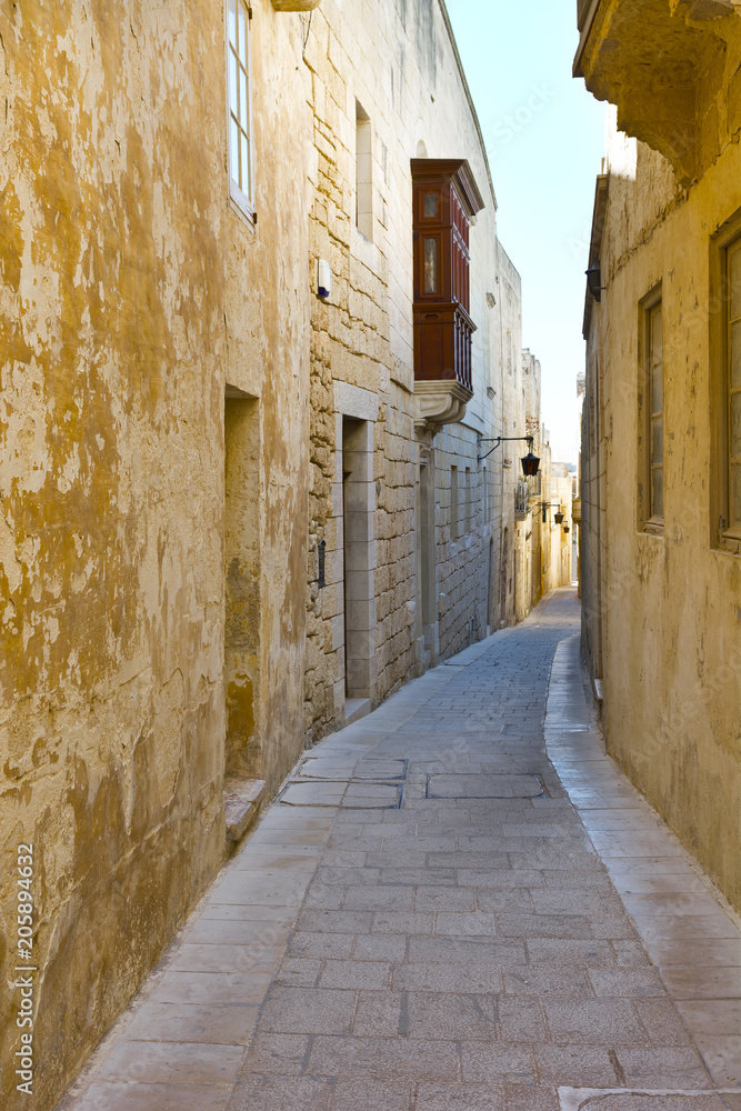Street with traditional maltese buildings in Mdina