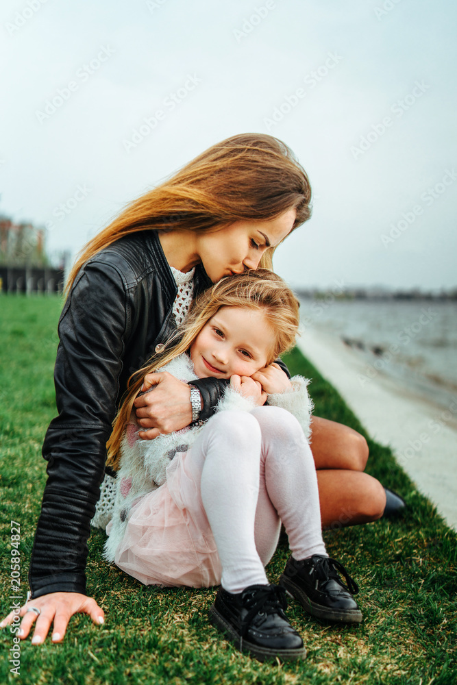 Mother with her little daughter have fun in the park Mother with her little daughter have fun in the park