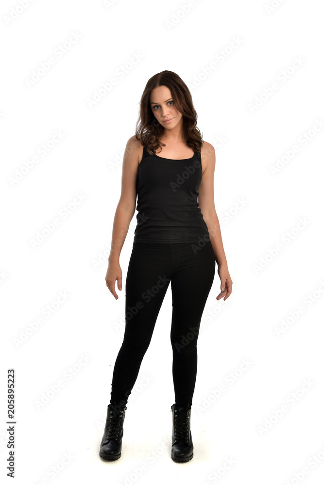 full length portrait of brunette girl wearing black singlet, jeans jeans and boots. standing pose, isolated on white studio background. full length portrait of brunette girl wearing black singlet, jeans jeans and boots. standing pose, isolated on white studio background.