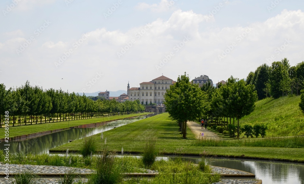 Venaria reale, Piedmont region, Italy. June 2017. The landscape of the gardens of the royal palace of Venaria. Vision from the ruins of the temple of Diana towards the palace. Tourists.