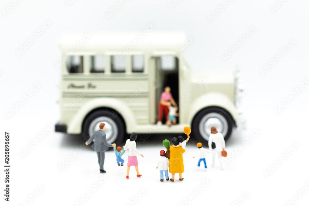 Miniature family: Parents are going to send children to the bus for go to school. Image use for education concept.