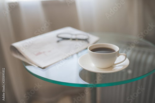A cup of coffee with a newspaper