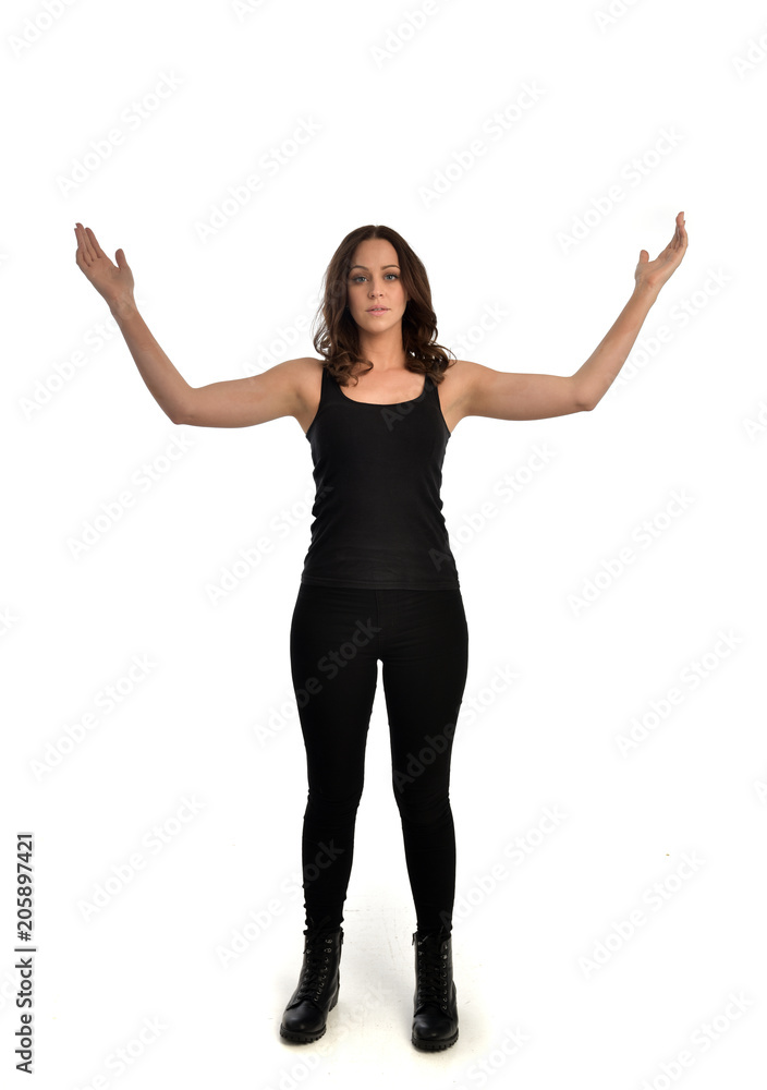 full length portrait of brunette girl wearing black singlet, jeans jeans and boots. standing pose, isolated on white studio background. full length portrait of brunette girl wearing black singlet, jeans jeans and boots. standing pose, isolated on white studio background.