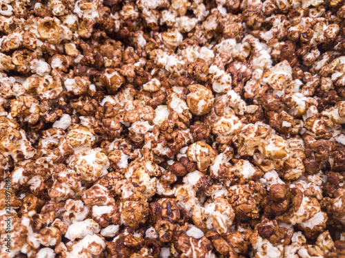 Scattered salted popcorn, texture background.