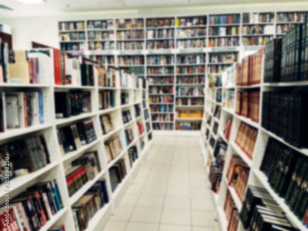 Rows of different colorful books lying on the shelves in the modern urban bookshop Rows of different colorful books lying on the shelves in the modern urban bookshop