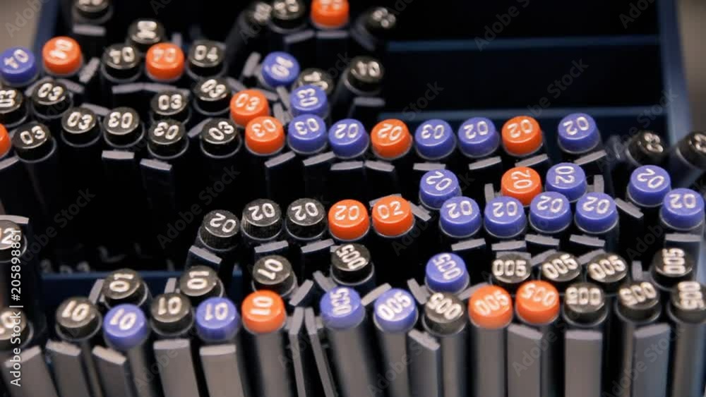 The hands of a customer choosing fine art pens from a shelf in a stationery shop. Front close-up detail shot.
The hands of a customer choosing fine art pens from a shelf in a stationery shop. Front close-up detail shot.