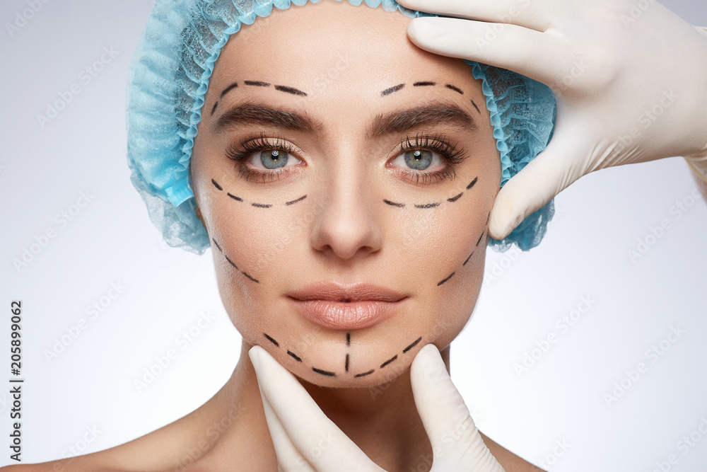 Beautiful model in blue cap with puncture lines on face