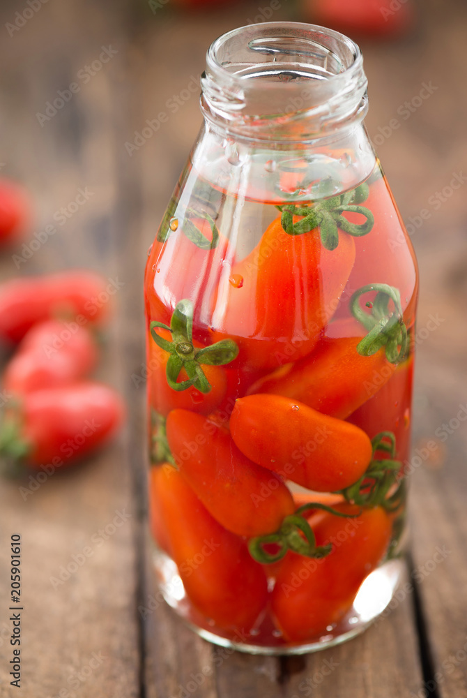 red tomatoes in bottle glass on wood
red tomatoes in bottle glass on wood